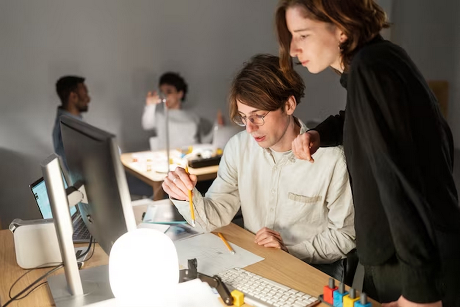 Man and woman working together in front of a computer